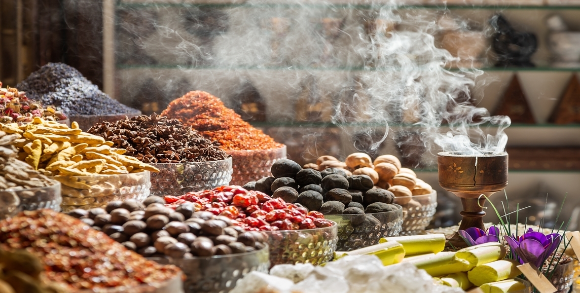 Authentic Turkish dried food in serving bowls on a table with incense smoking in a holder