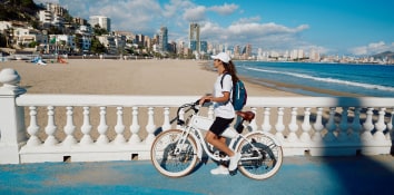 Girl riding bike at Levante beach