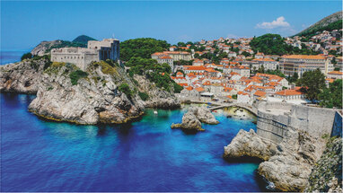 Dubrovnik town with rocks around sea.