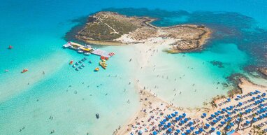 Paphos beach with small island.