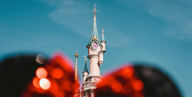 Disneyland castle behind Minnie ears.