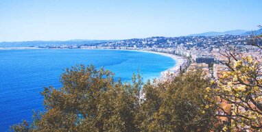 Nice bay with buildings, blue sea and trees.