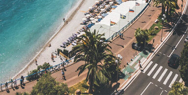 Nice beach, path and road with palm trees.