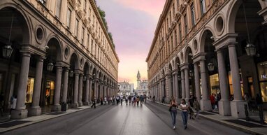 People walking between 2 buildings in Turin.