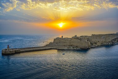 Sunrise in Valletta over sea.