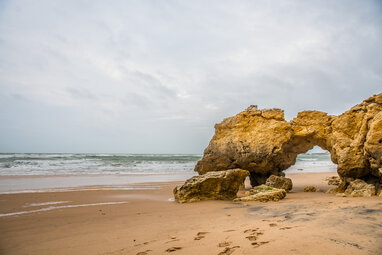 Algarve rock arch on beach
