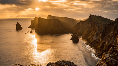 Madeira cliffs and sea at sunset.
