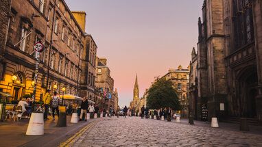 Edinburgh town road and buildings at sunset.