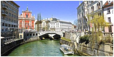 Ljubljana river with buildings and bridge.