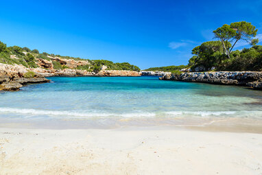 Mallorca sandy beach with clear water and blue sky.