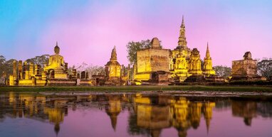 Temple with reflection in water and sunset.