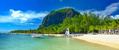 Mauritius beach with boats in the sea and white sand.
