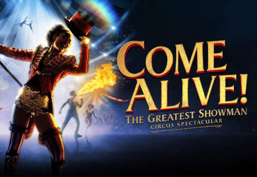 Promo image for Come Alive The Greatest Showman Circus Spectacular featuring a ringmaster with a top hat, fire effects, and acrobats