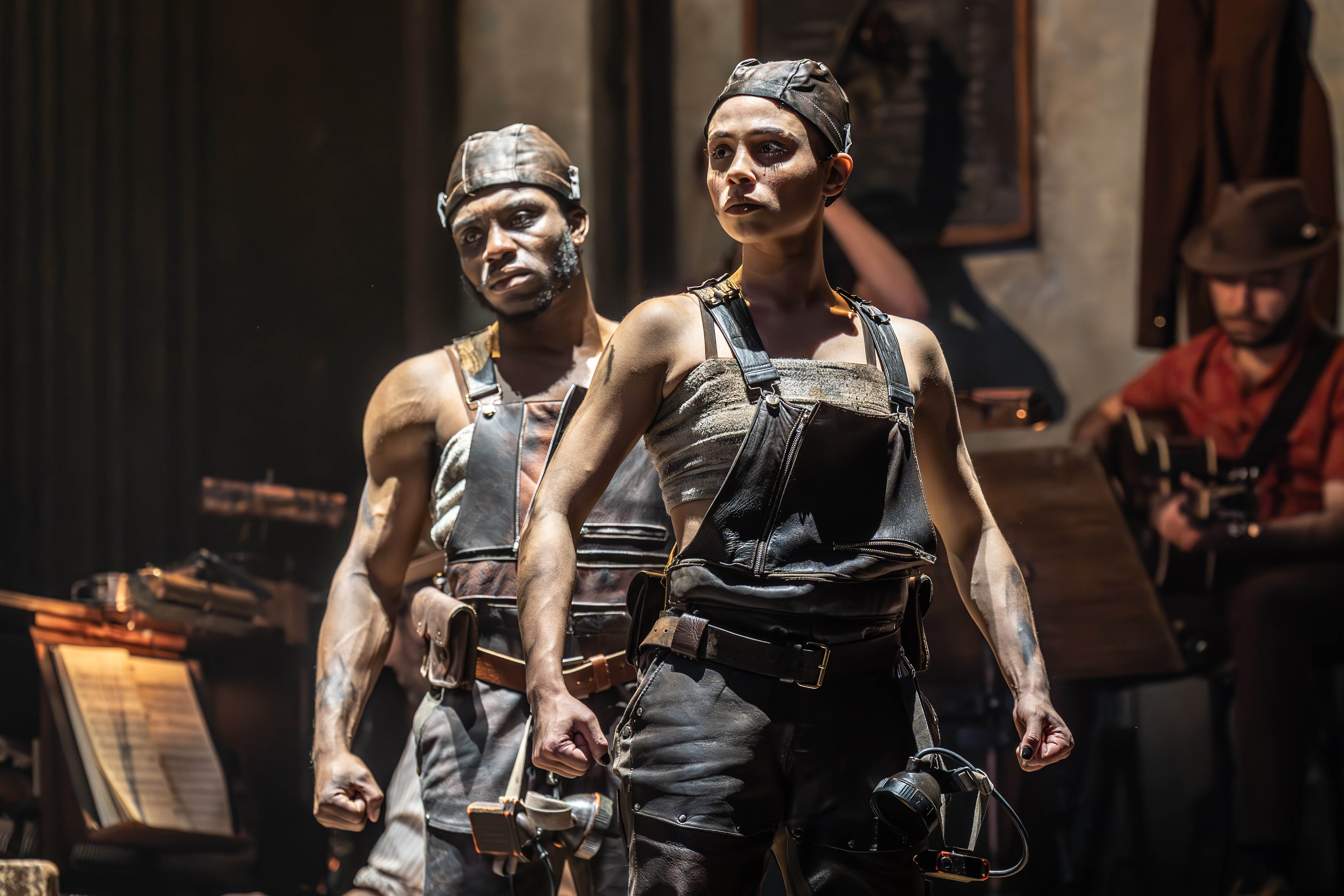 Hadestown cast silhouetted against a dramatic backdrop – photo by Marc Brenner