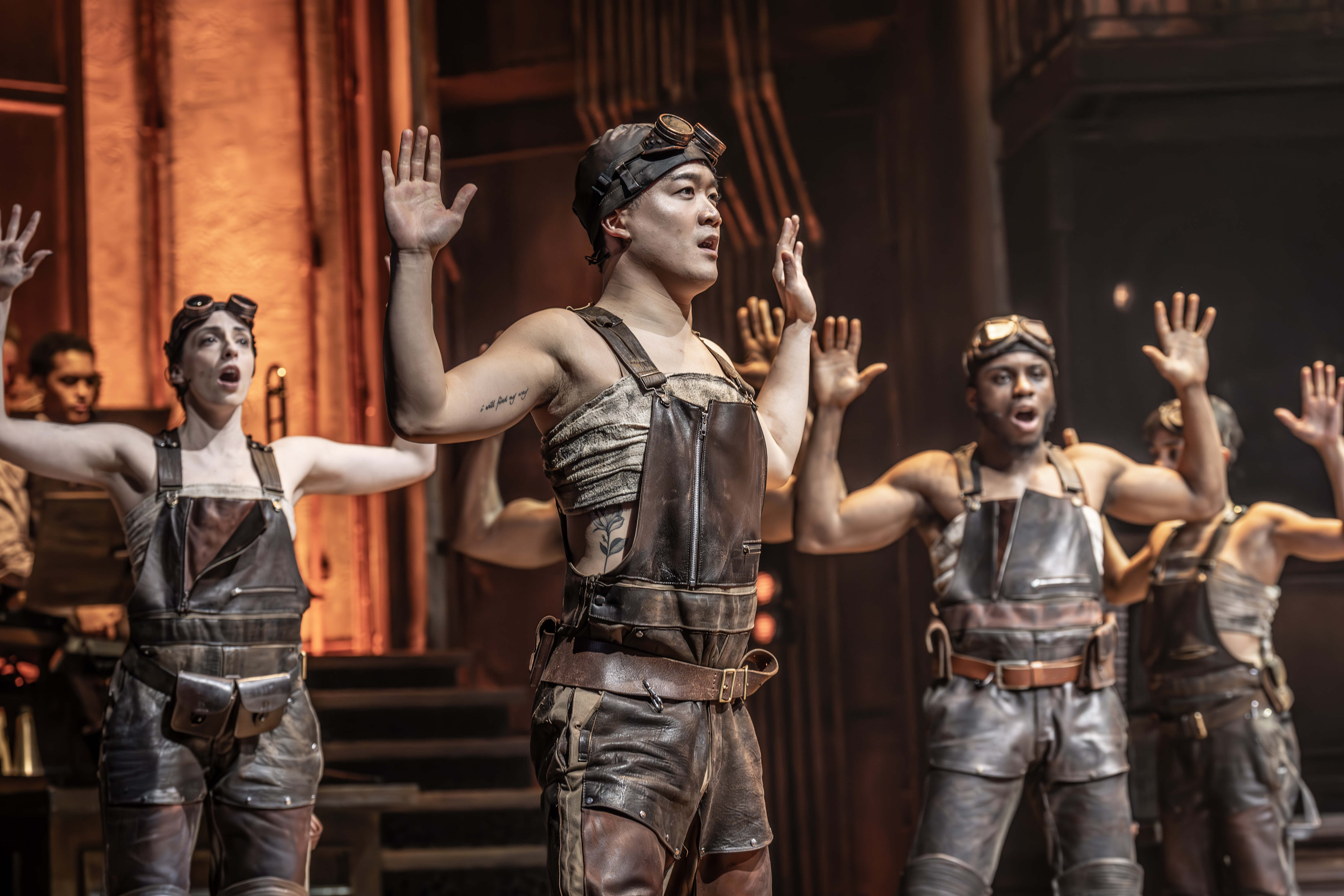 A chorus number from Hadestown with layered staging – photo by Marc Brenner