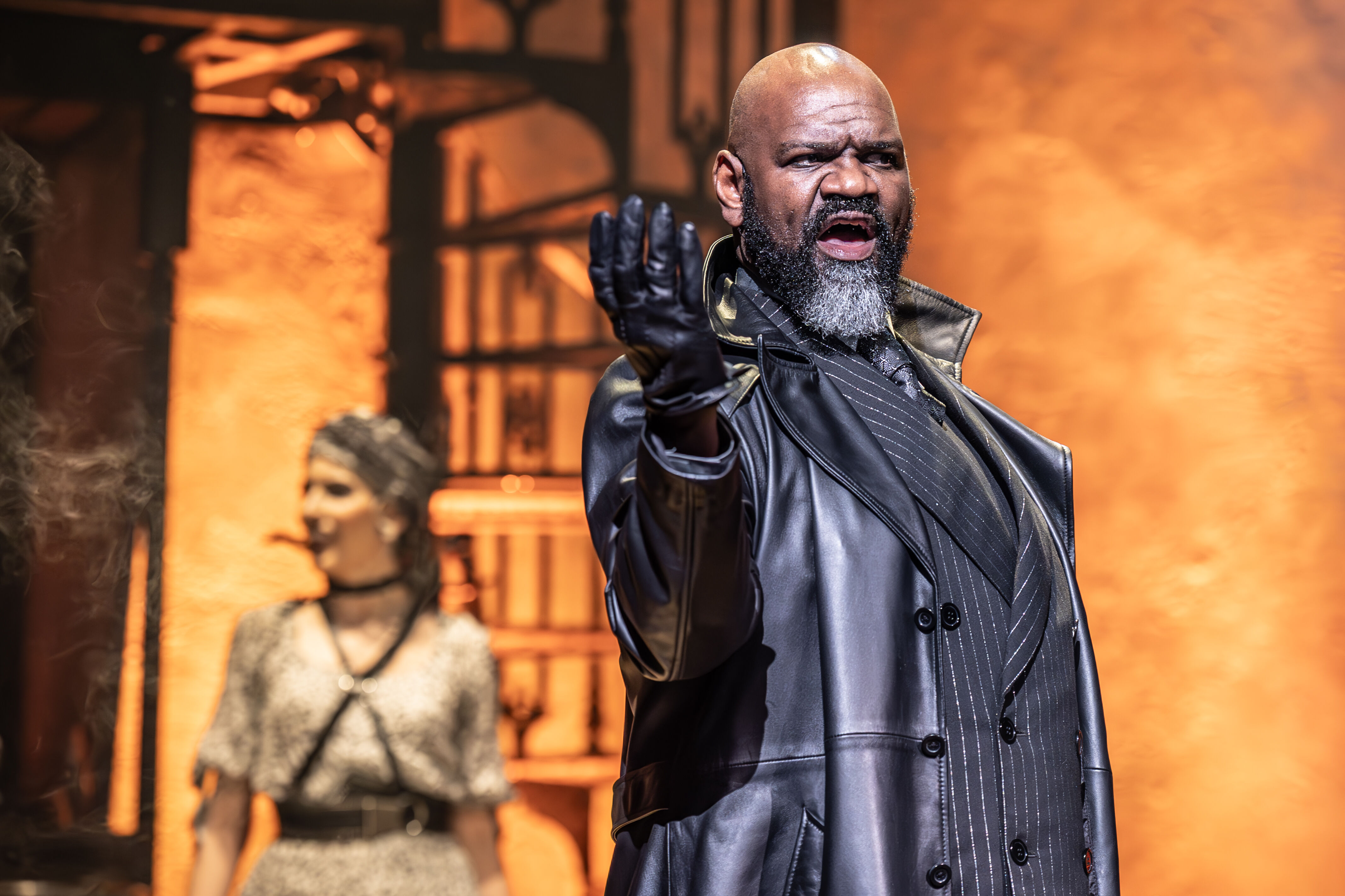 Atmospheric moment from Hadestown with rich stage lighting – photo by Marc Brenner
