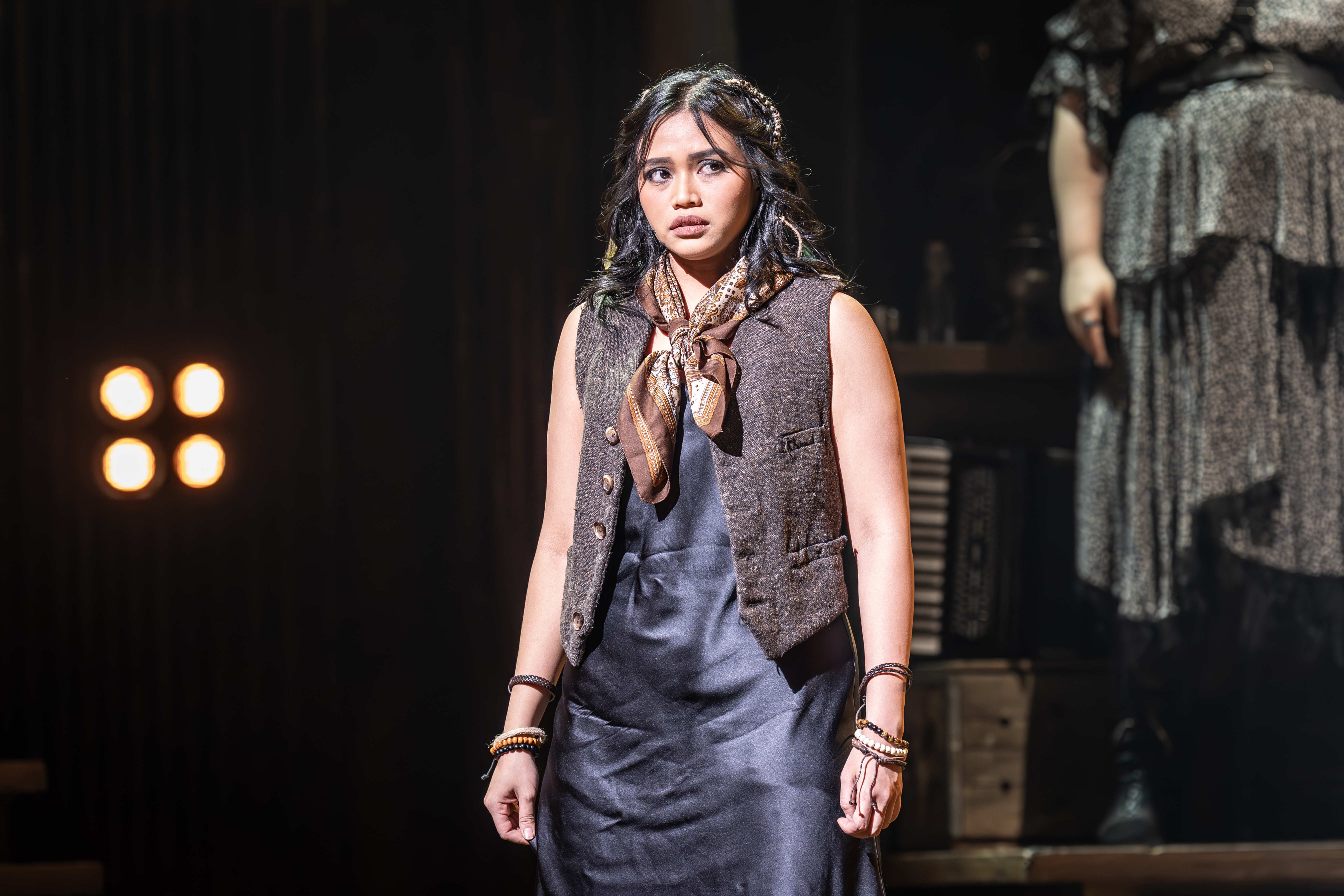 Cast of Hadestown singing beneath golden lighting – photo by Marc Brenner