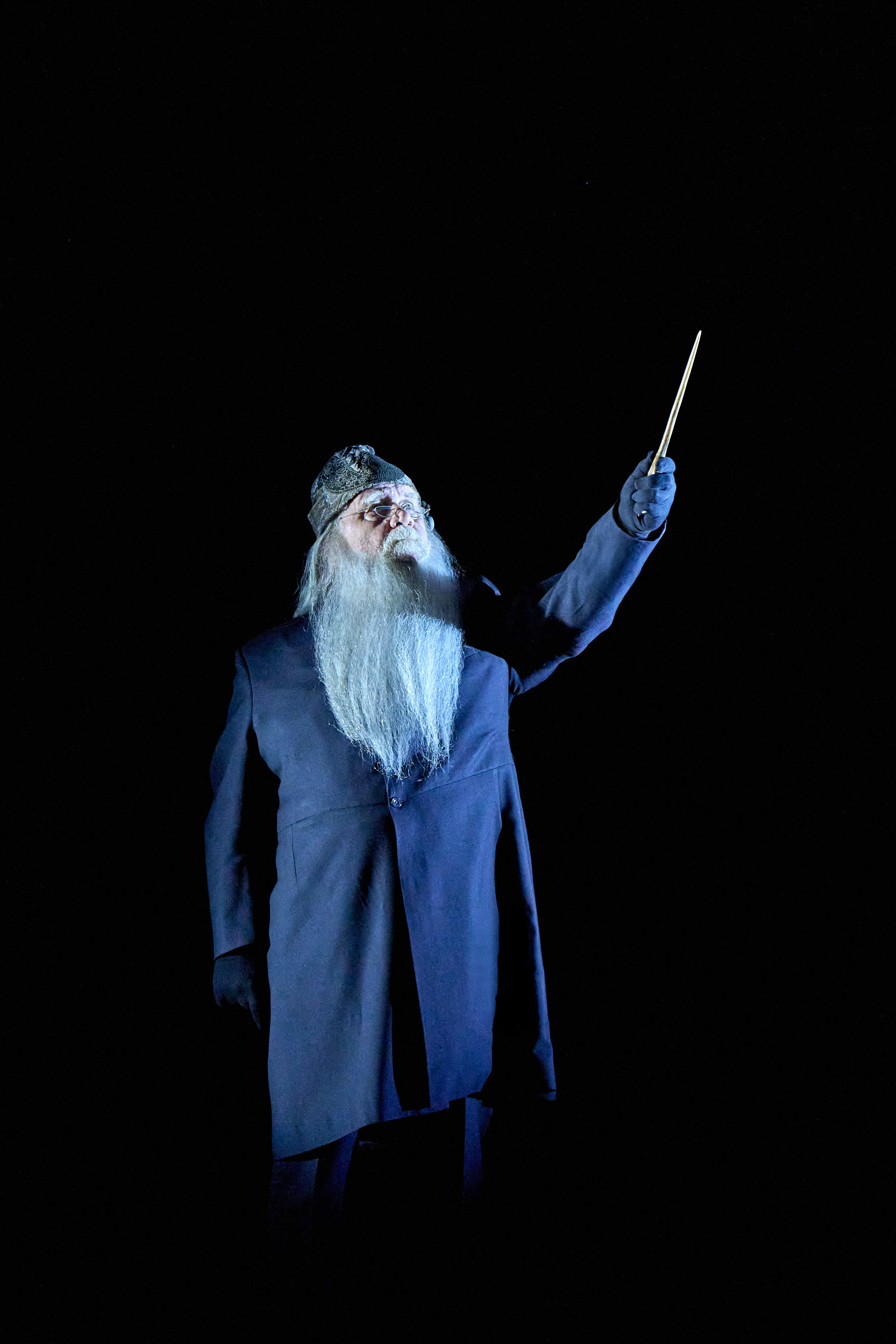 Characters examining a magical map with wands, as they uncover secrets, from Harry Potter and the Cursed Child.