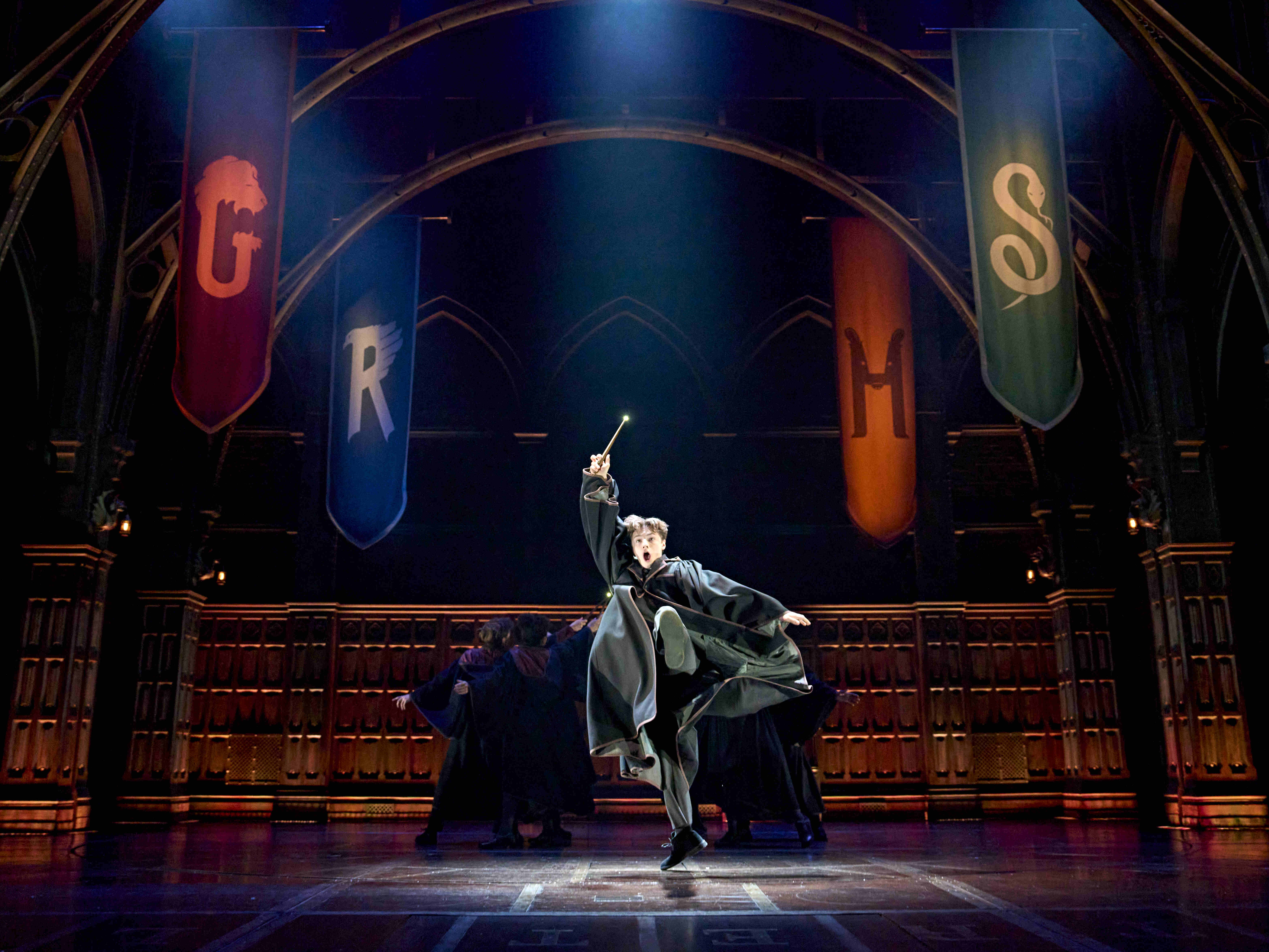 Character in casual clothing, sitting on a staircase with a serious expression, from Harry Potter and the Cursed Child.