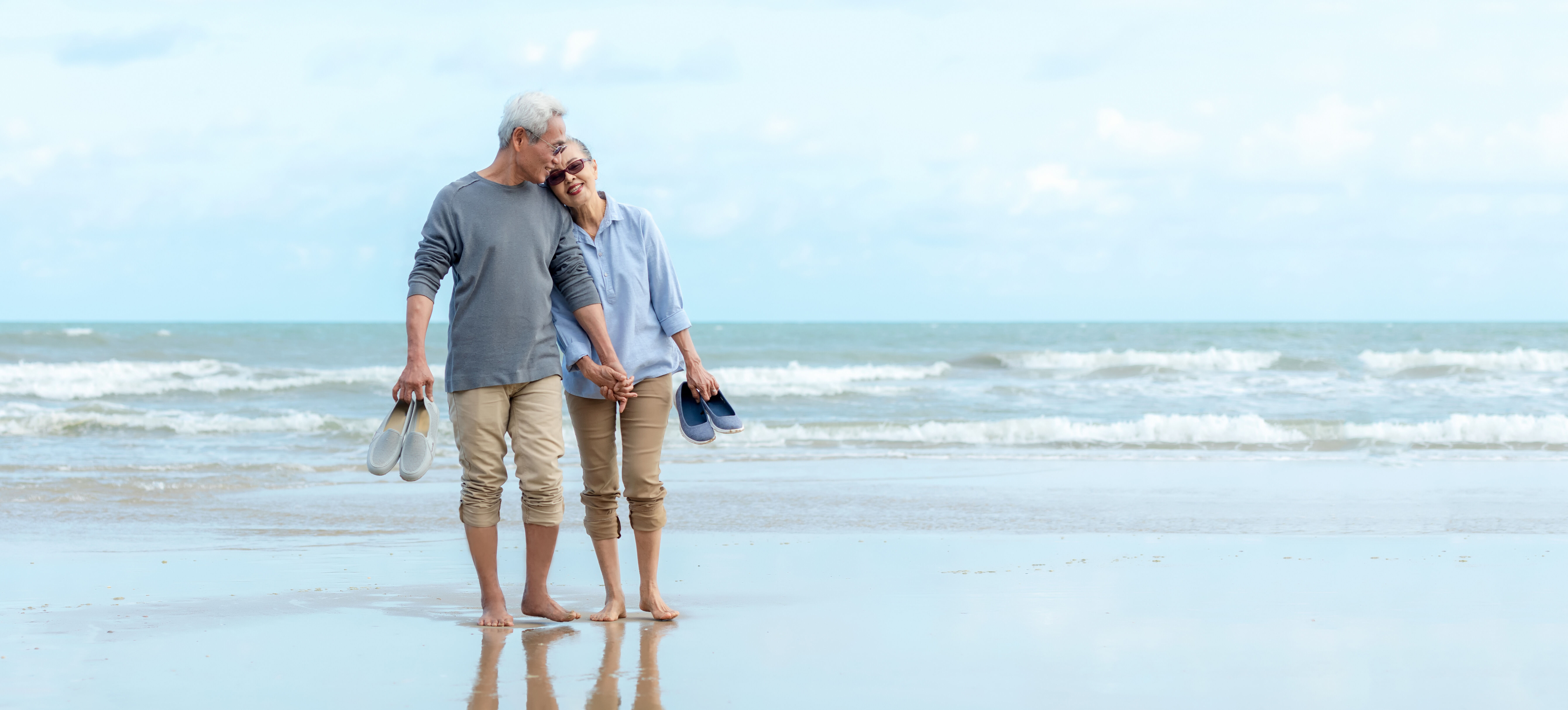 Older couple enjoying a walk on the beach.