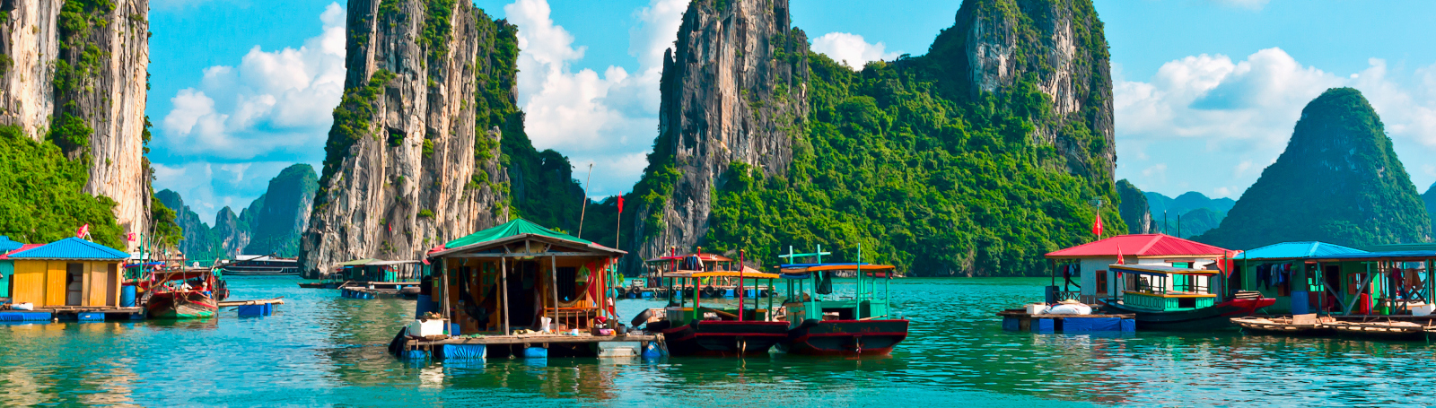 An aerial view of a cruise ship with a large pool deck visible at the rear, and a spacious area with lounge chairs and sunbeds.
