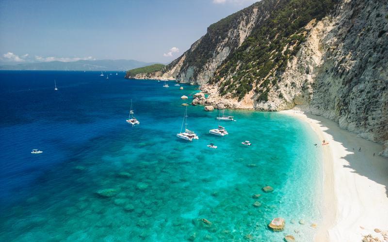 White limestone cliffs and turquoise waters along the coastline of Ithaca, Greece.