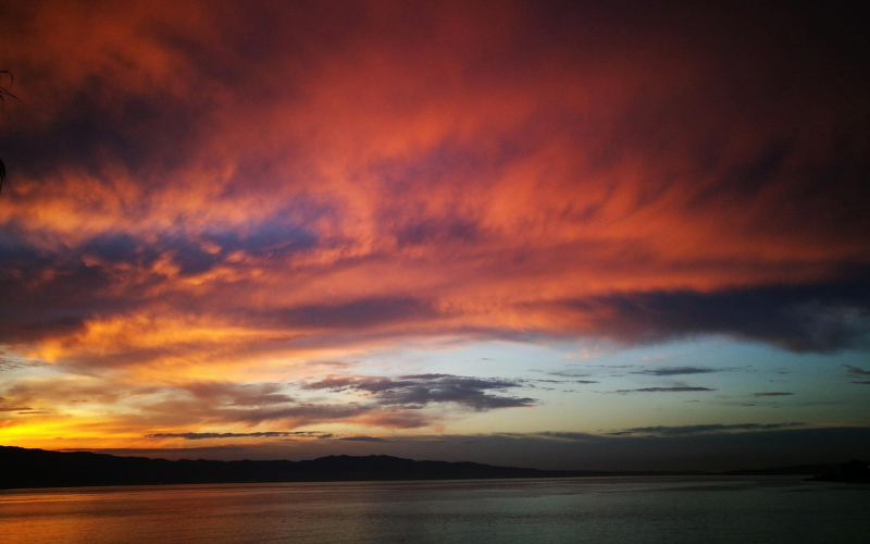 Colourful sunset over the Strait of Messina between Sicily and mainland Italy.