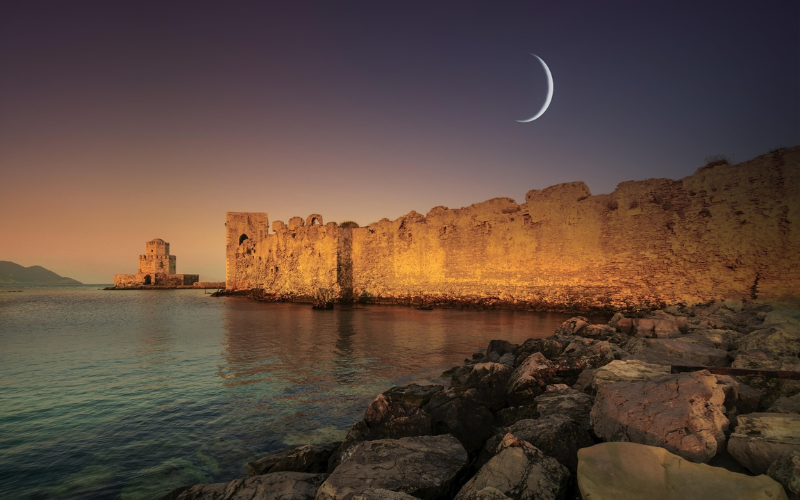 Methoni Castle at dusk with its sea tower overlooking the sea in southwest Greece.