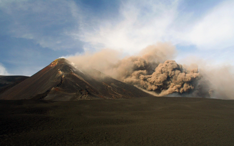 Ash cloud rising from Mount Etna during a volcanic eruption in Sicily.