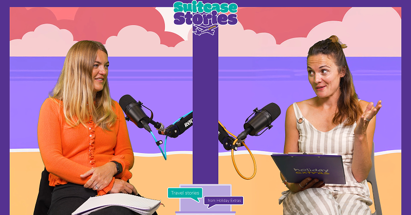 Two women, including author Sophie Haydock, recording a podcast episode of Suitcase Stories with microphones, notes, and a colorful beach-themed background.