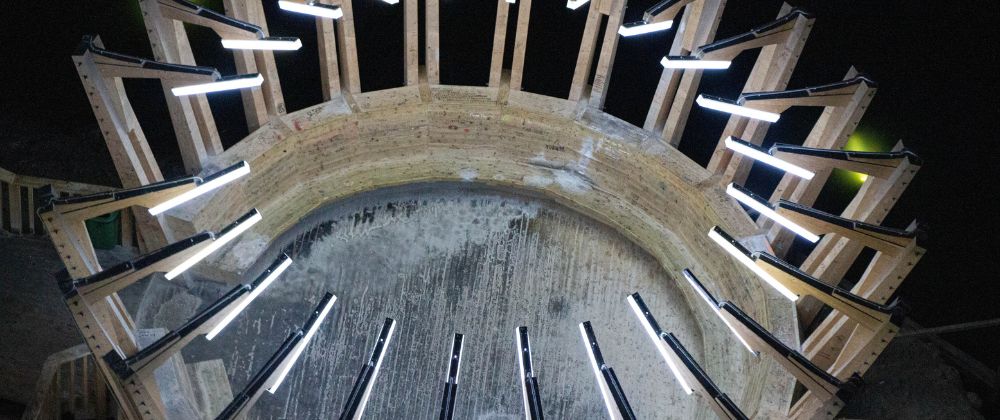 Circular illuminated structure inside the vast underground Salina Turda salt mine in Romania.