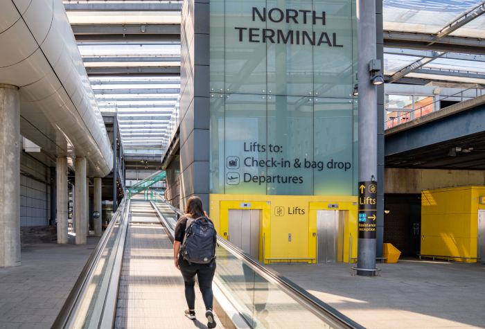 Female traveller walking toward the North Terminal at Gatwick Airport after dropping off her car with Ace Meet & Greet