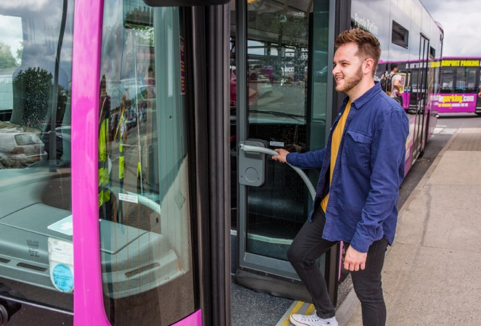 Man boarding a Purple Parking Park & Ride shuttle bus from the car park to Gatwick Airport