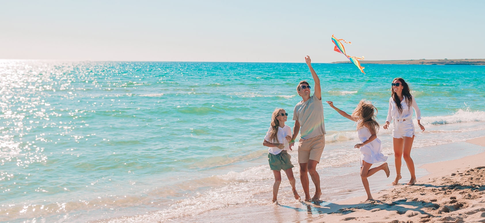 family on the beach with a kite