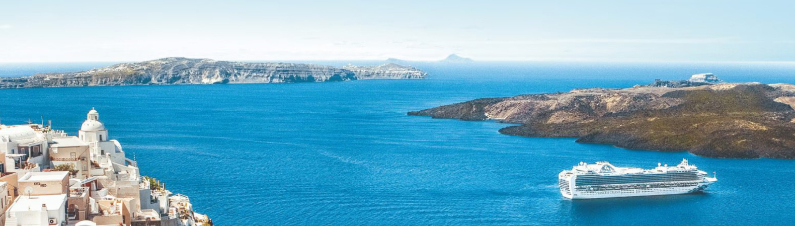An aerial view of a cruise ship with a large pool deck visible at the rear, and a spacious area with lounge chairs and sunbeds.