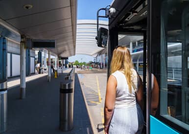 woman getting off bus