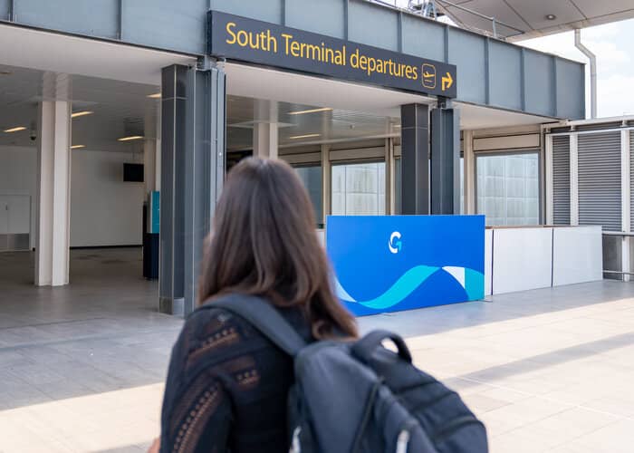 Woman looking at sign for gatwick airport south terminal