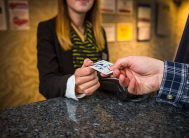 hotel check in desk handing over card