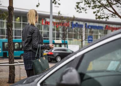woman looking at liverpool airport terminal
