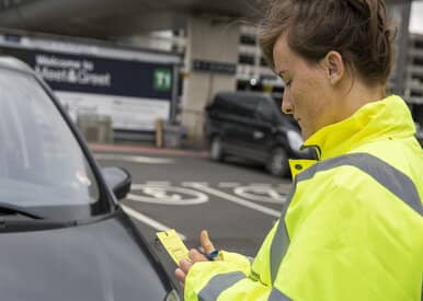 worker checking car keys at meet and greet car park
