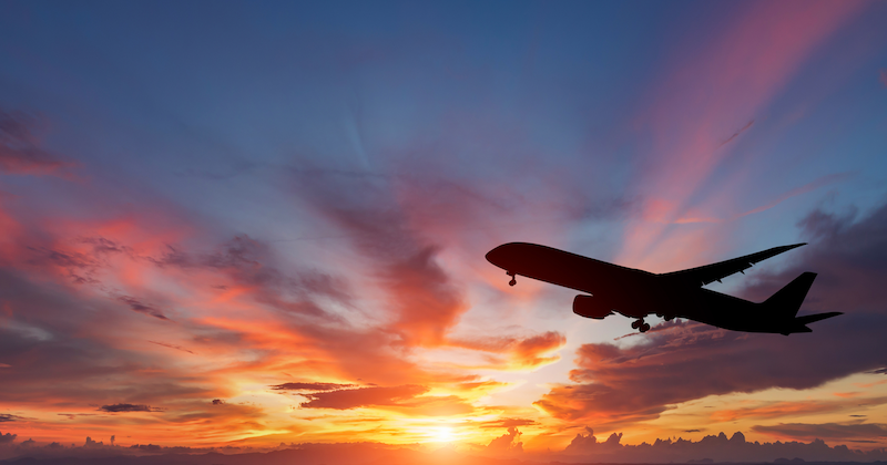 Plane against sunset