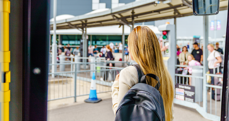 A British traveller navigating a busy airport with luggage