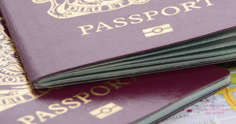 UK passports and boarding passes on an airport check-in desk.